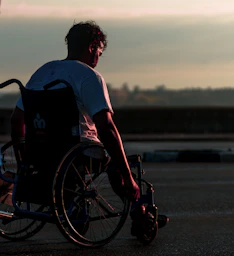 man riding on wheelchair during daytime