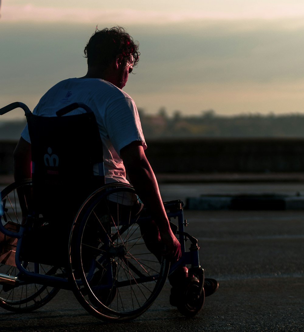 man riding on wheelchair during daytime