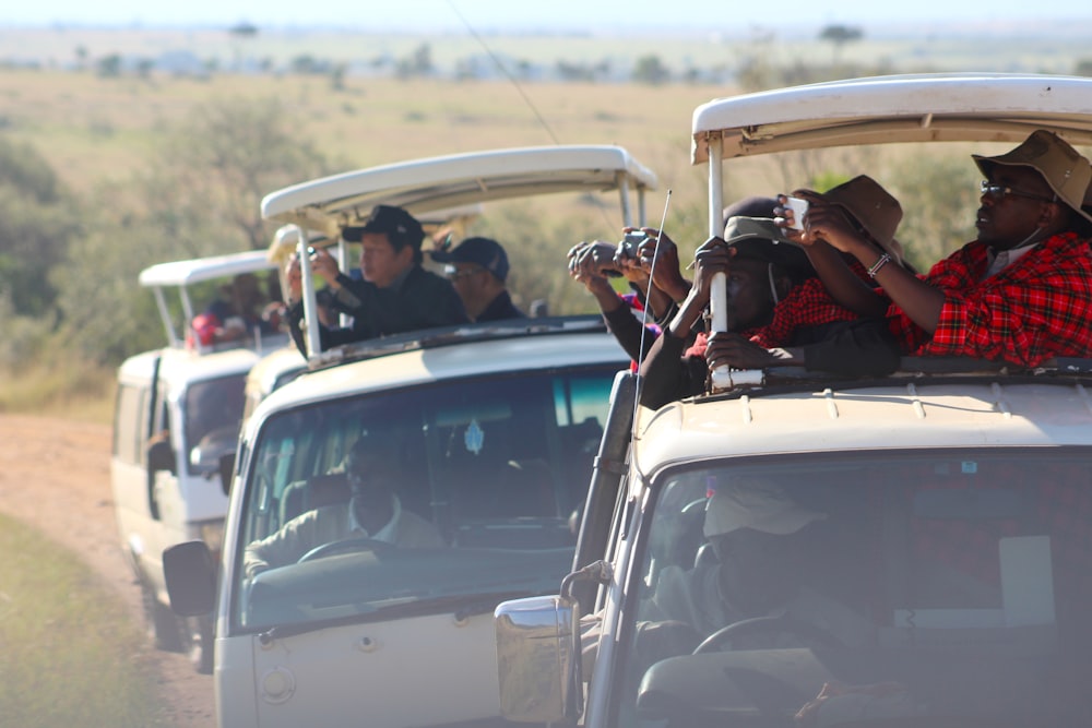 people riding pickup truck taking photo