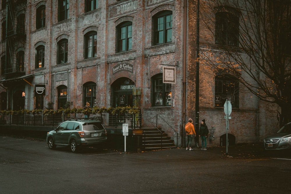 silver SUV parked beside brown concrete building