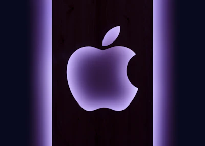 Apple Podcasts symbol glowing softly in white and blue on a dark, mysterious background.