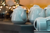A showcase of elegant porcelain tea sets reflecting soft natural light.
