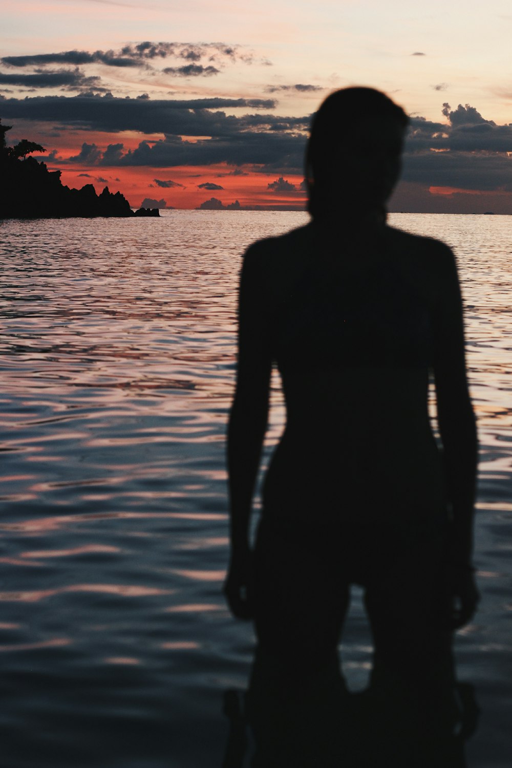 silhouette of person standing on water