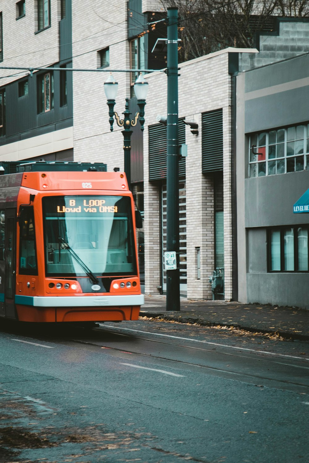 orange and black vehicle on road at daytime