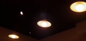 A series of ceiling lights illuminating a cozy kitchen.