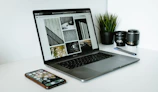 Photo of a sleek laptop with multiple productivity apps open on screen.