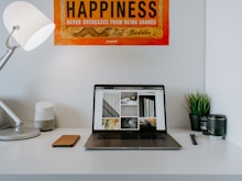 turned-on laptop near desk lamp