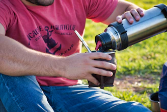 man pouring on mug