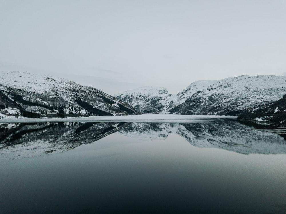 snow covered mountain and body of water