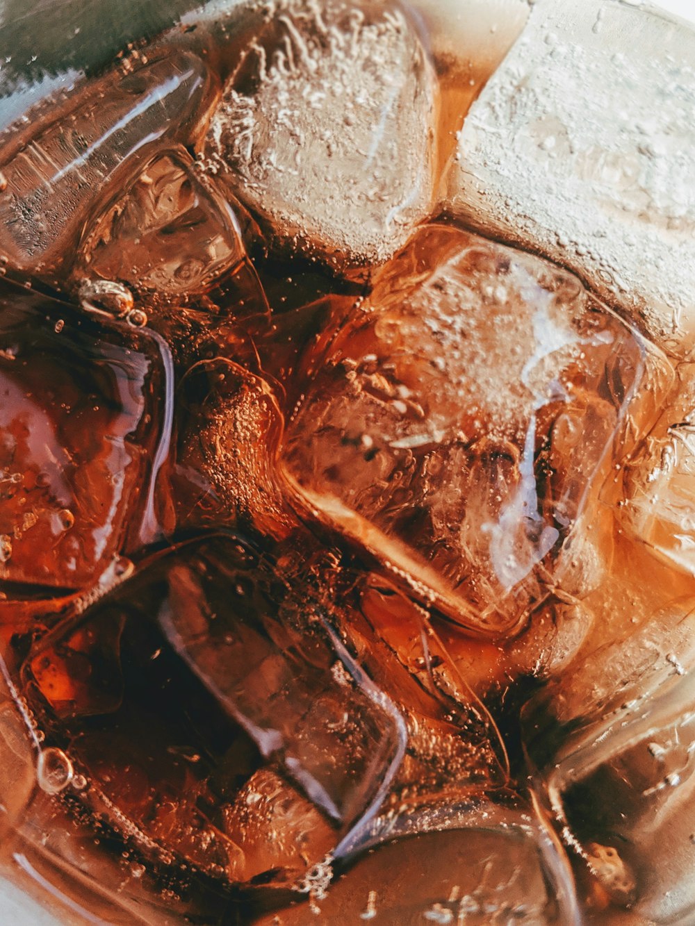 drinking glass filled with soda and ice