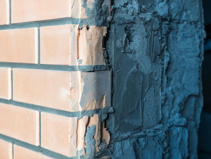 Close-up of a freshly plastered facade wall with smooth texture under natural daylight.