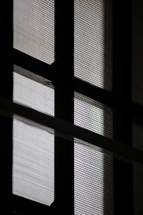 Close-up of elegant window screens with fine mesh texture.