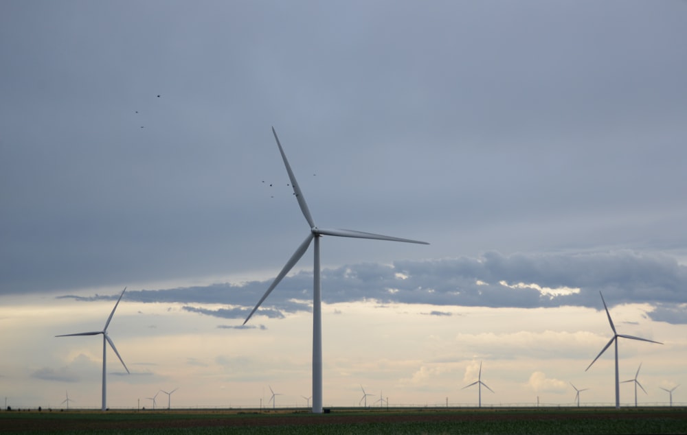 white wind mill during daytime