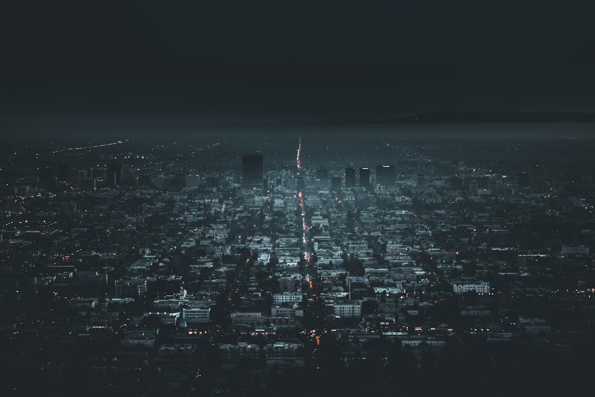 Aerial view of a city neighborhood in near-total darkness during a power outage