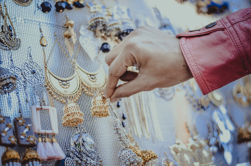 person touching gold earrings