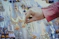 person touching gold earrings