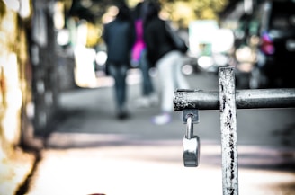 A friendly locksmith working on a metal gate in an urban neighborhood.