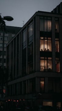 Modern residential building with warm lighting at dusk