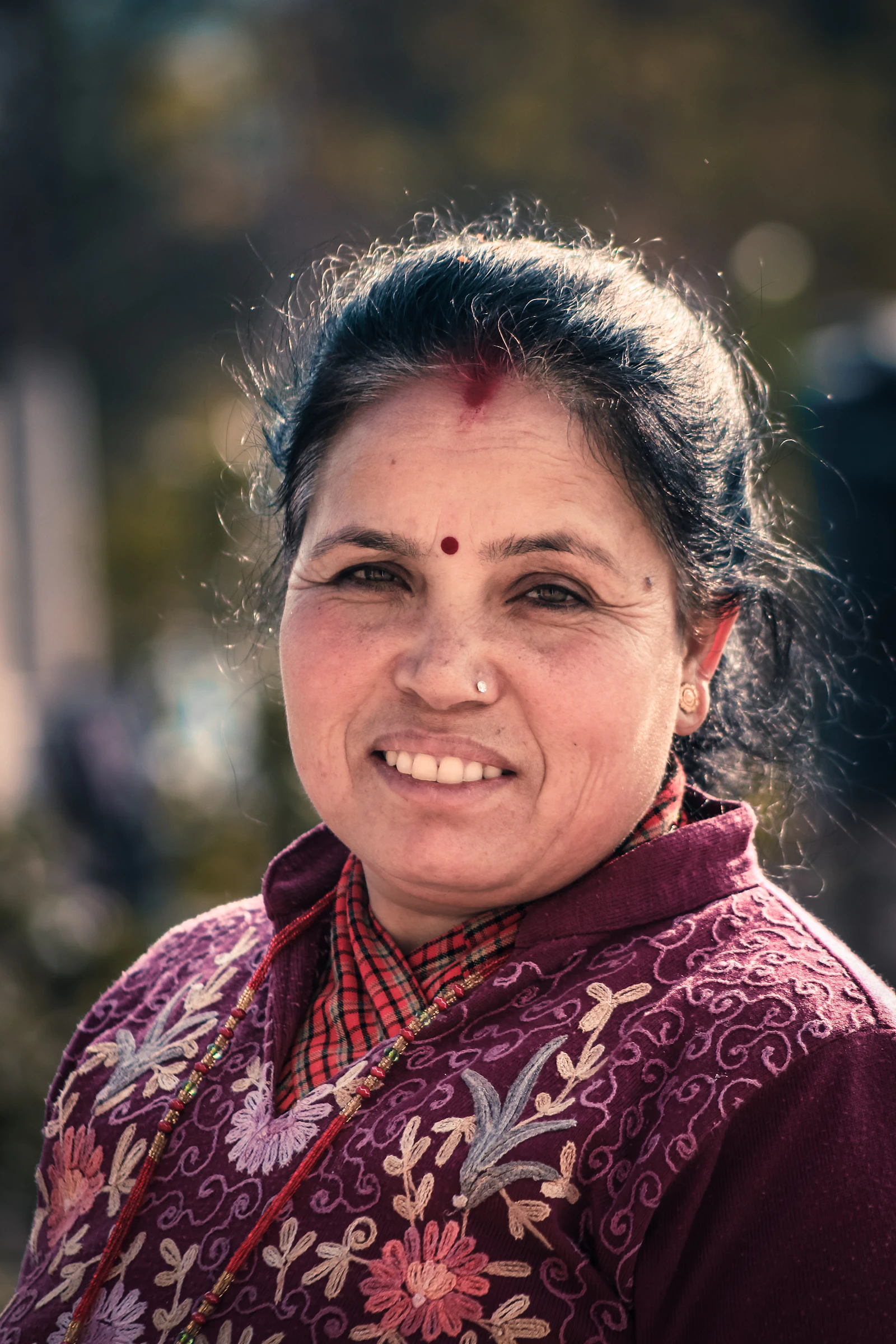 A smiling woman photographed outdoors