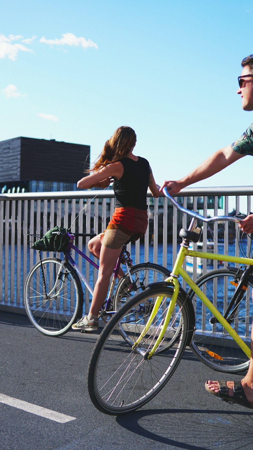 woman riding bike near railings