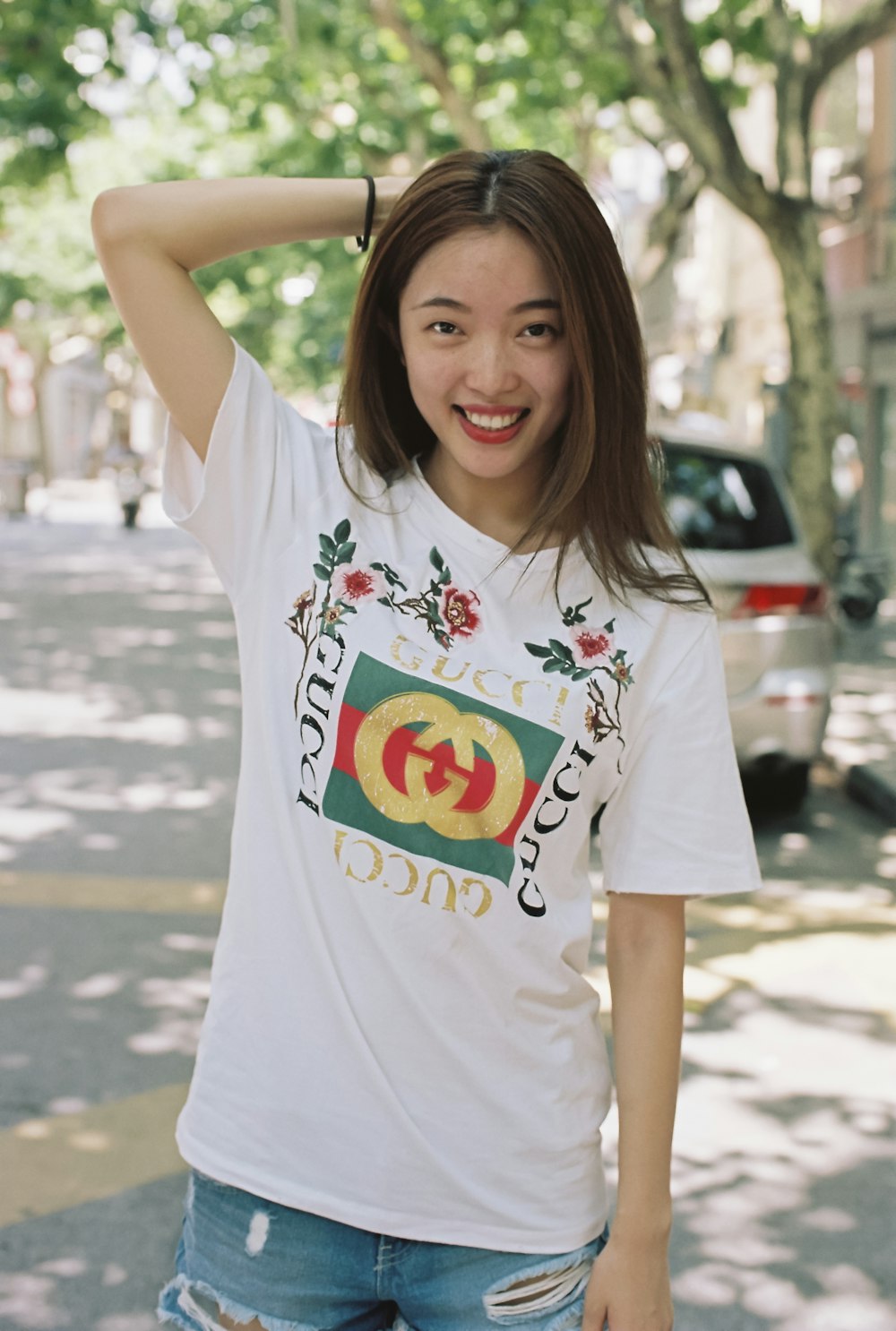 smiling woman wearing white shirt near vehicle during daytime