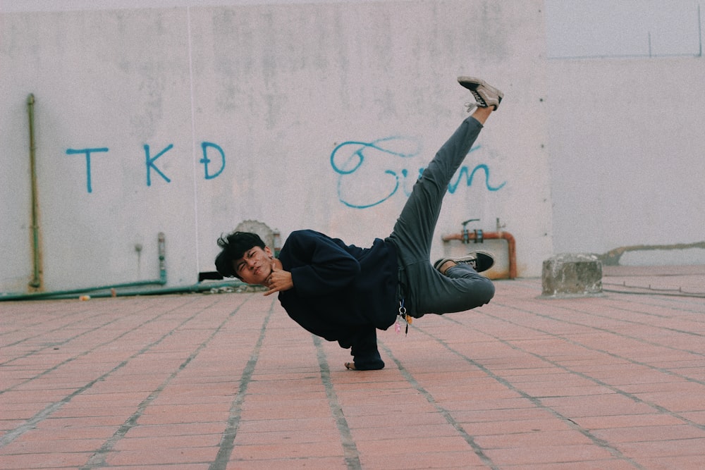 man doing 1 hand stand