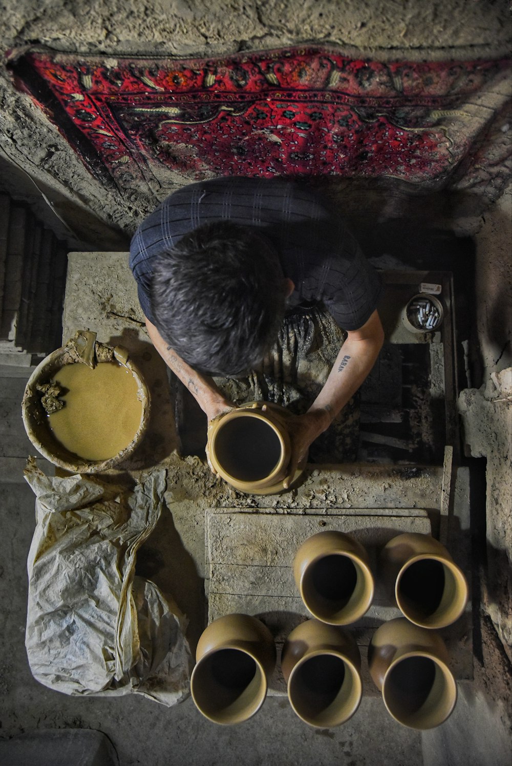 man making pots on top view