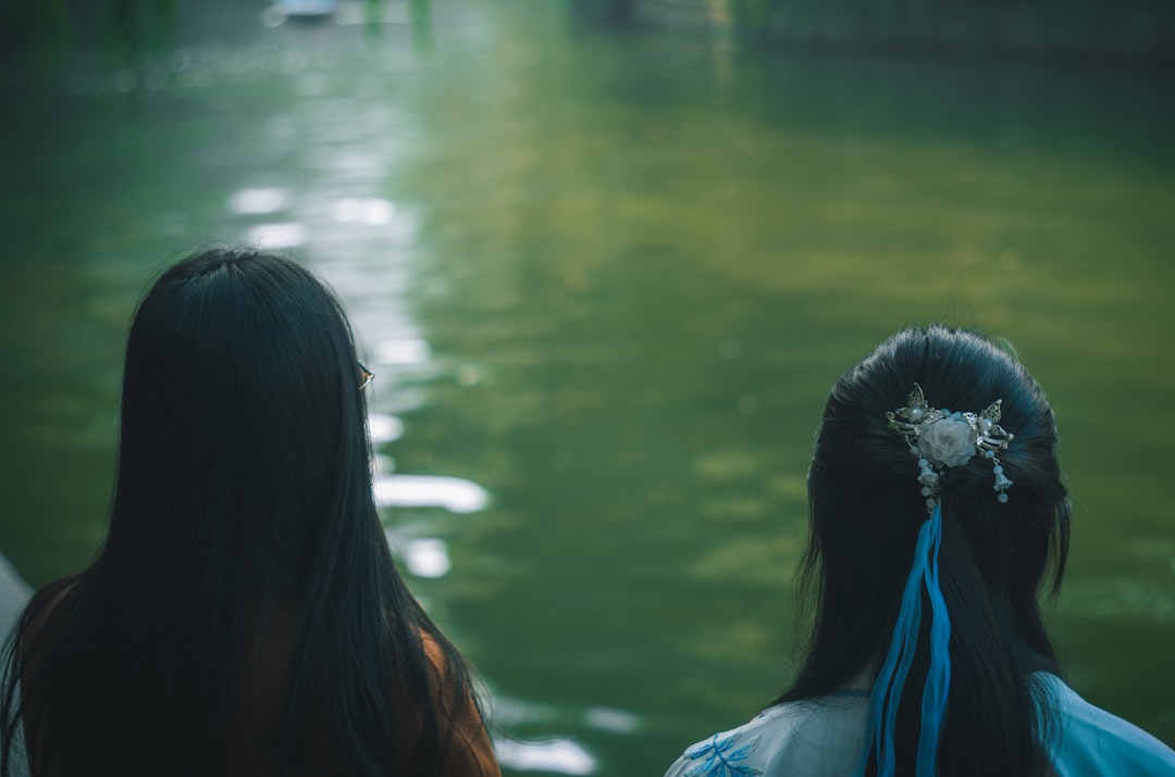 two women near body of water