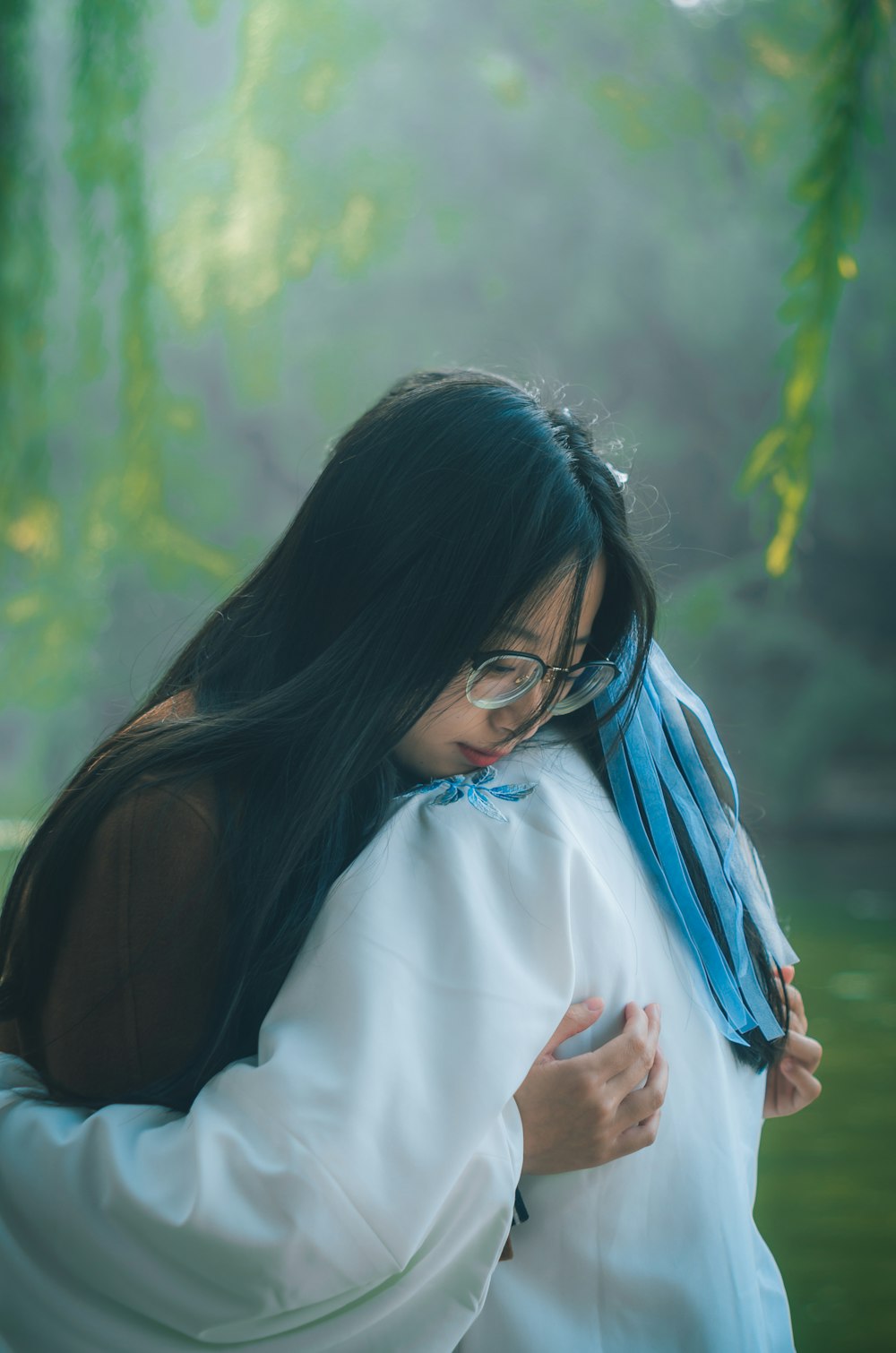 two women hugging during daytime