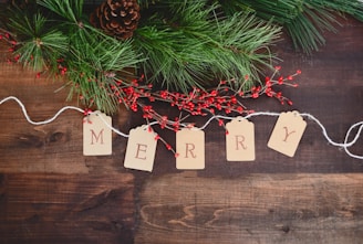 MERRY text cutout on white string by wreath