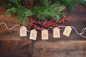 MERRY text cutout on white string by wreath