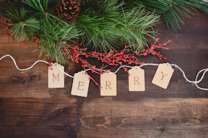 MERRY text cutout on white string by wreath