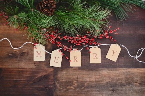 MERRY text cutout on white string by wreath