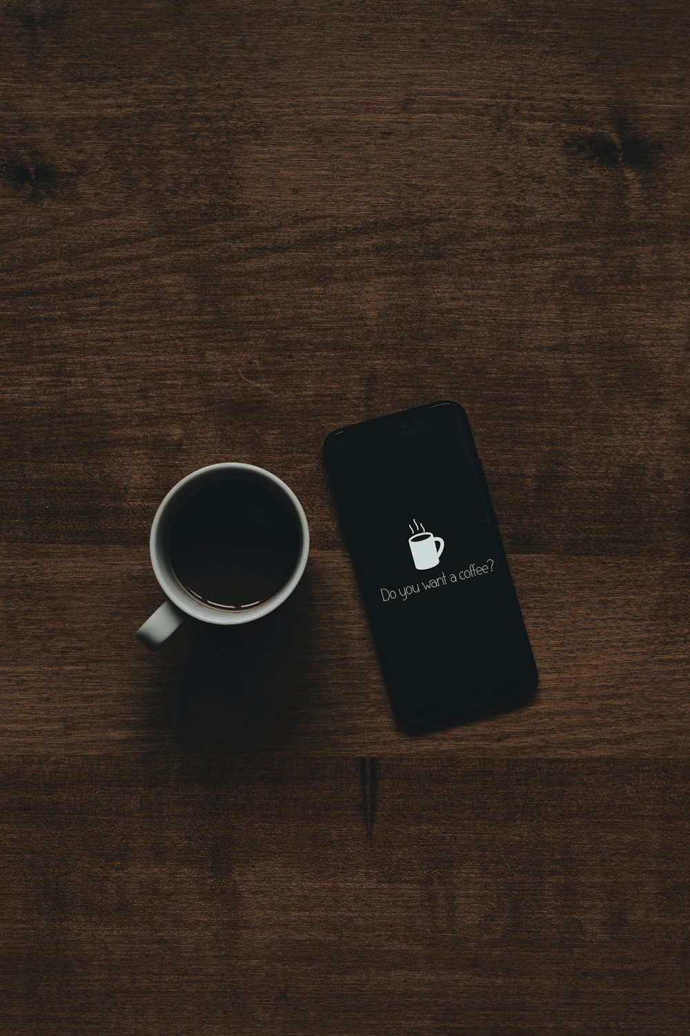 white ceramic mug on brown wooden surface