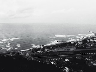 An 8-bit coastal highway with palm trees swaying against a pixel ocean backdrop.