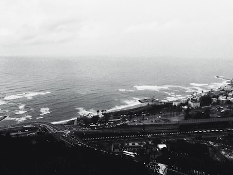 An 8-bit coastal highway with palm trees swaying against a pixel ocean backdrop.