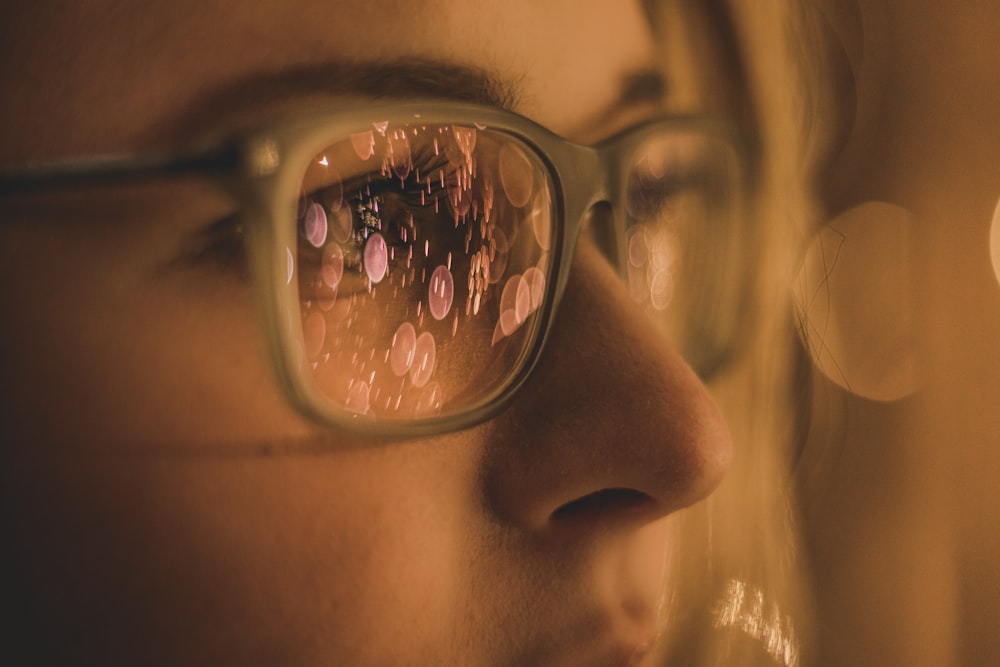 woman wearing eyeglasses in close-up photo