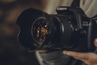 black Canon EOS 1300D DSLR camera