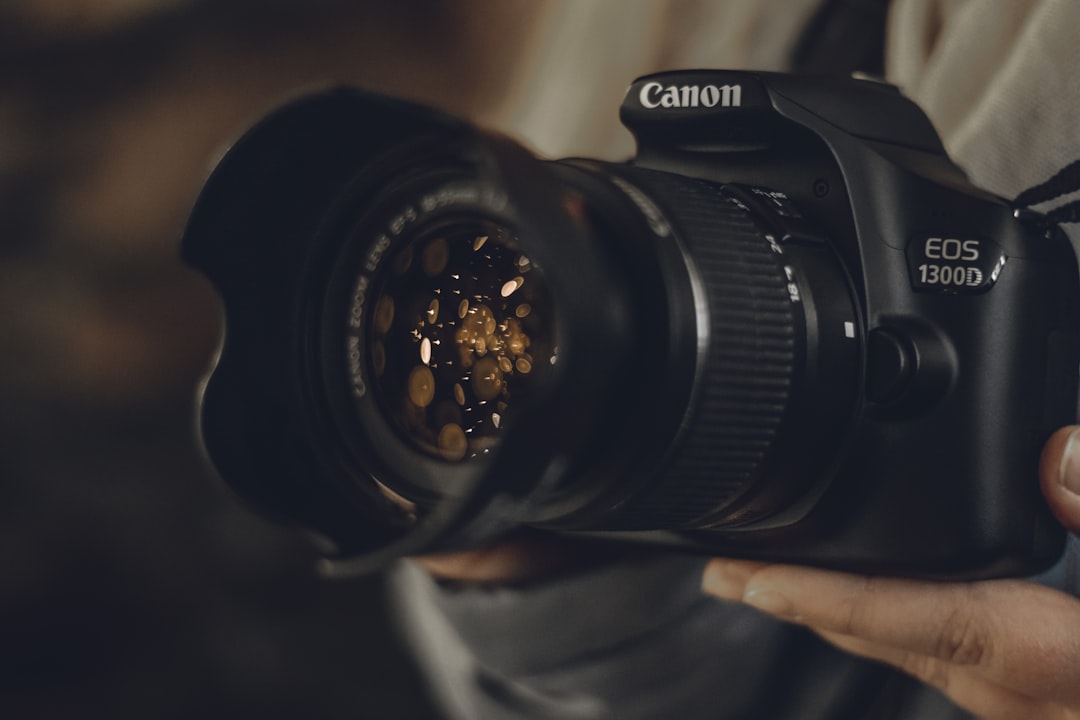black Canon EOS 1300D DSLR camera