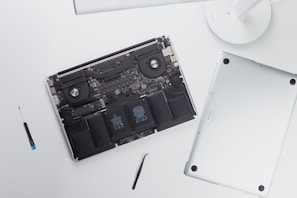 A detailed shot of an open laptop showing internal components during a repair.