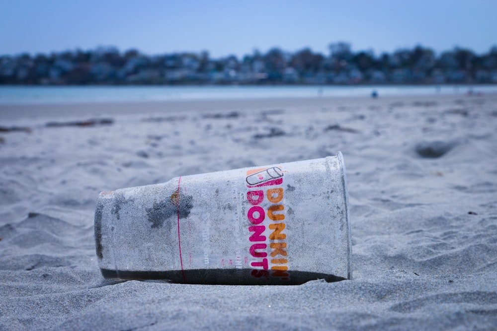 Dunkin Donut disposable cup on the sand