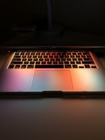 A laptop keyboard illuminated by soft ambient light during a review session.