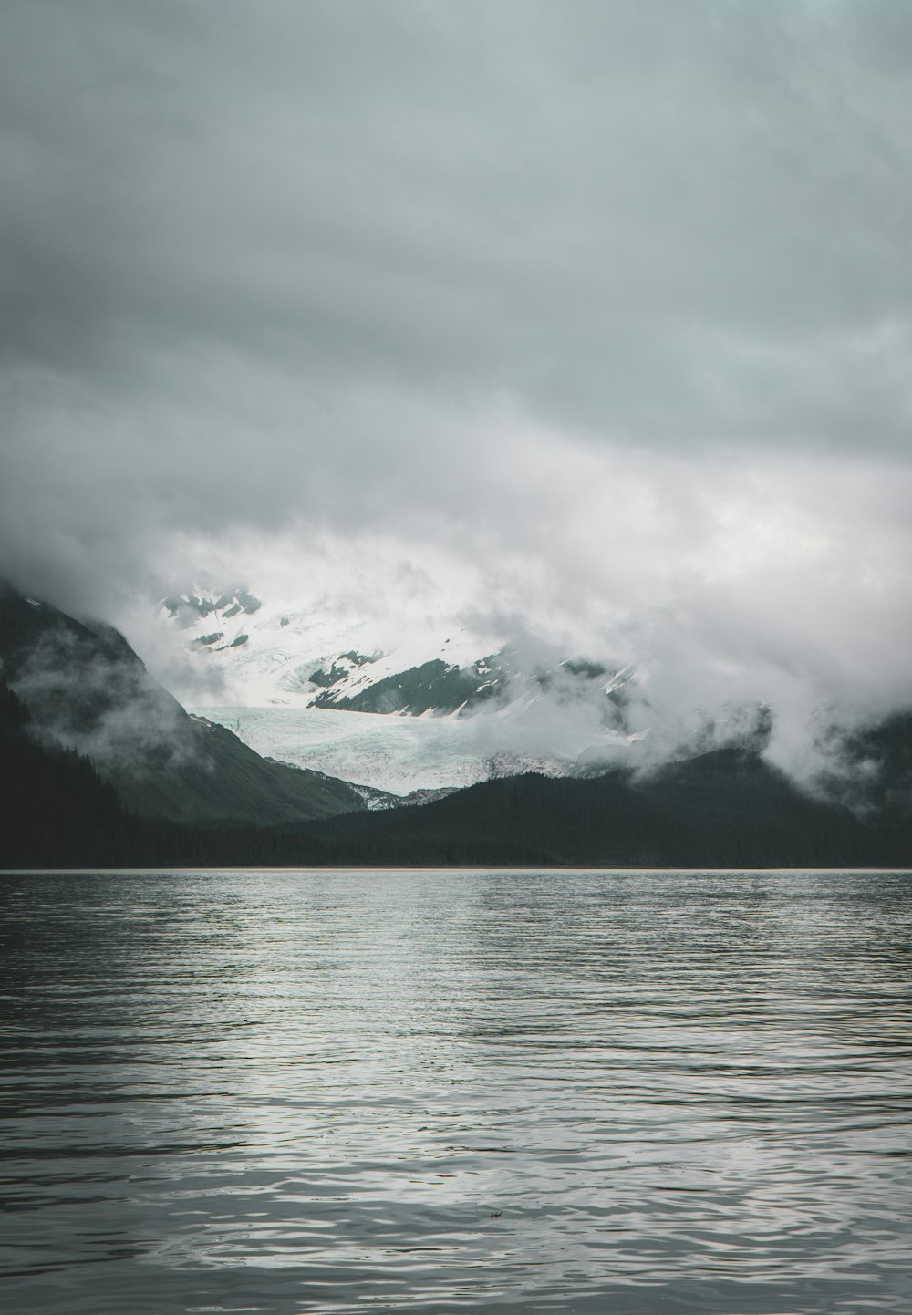 snow capped mountain beside body of water