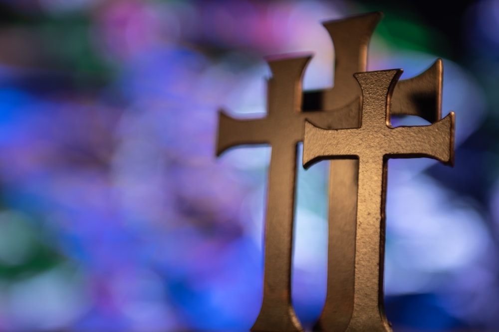 several gold-colored cross table decors in selective focus photography