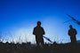 silhouette of 2 person at field during daytime