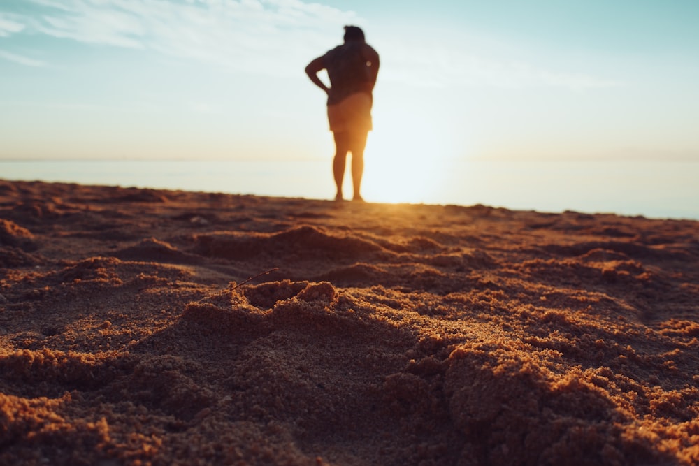 standing person on brown sand