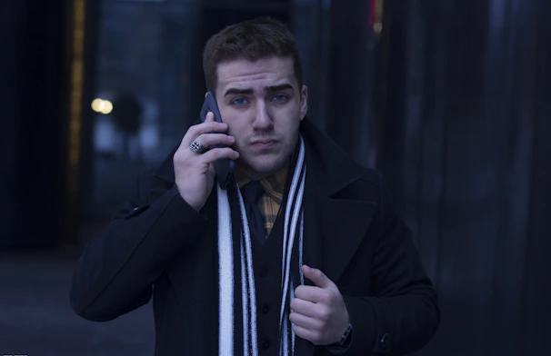 Close-up of a dispatcher coordinating routes over the phone with a focused expression.