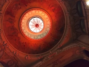 A beautifully restored ceiling with intricate details and warm ambient lighting highlighting repair work.