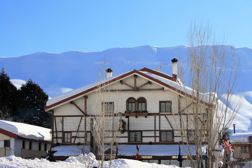 white and black concrete house near mountain during daytime