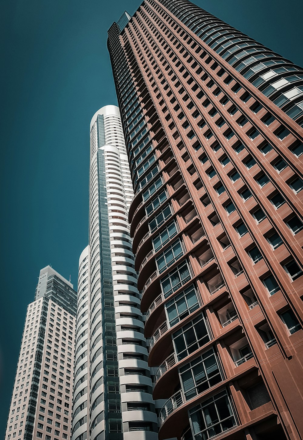 low-angle photography of several high-rise glass buildings